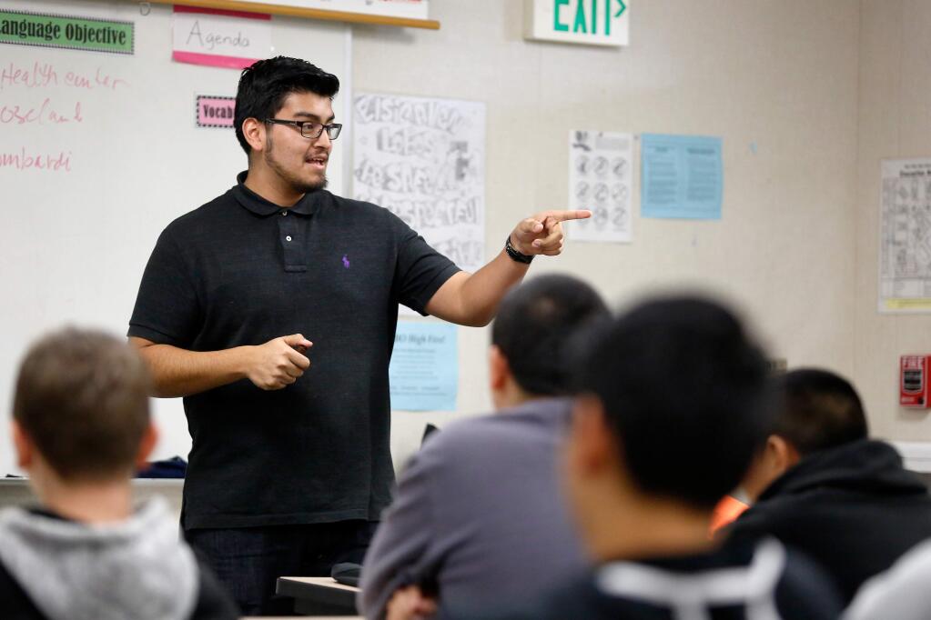 Andres Correa calls on a student as he teaches a sexual education class at Elsie Allen High School in Santa Rosa, California on Thursday, December 10, 2015. (Alvin Jornada / The Press Democrat)