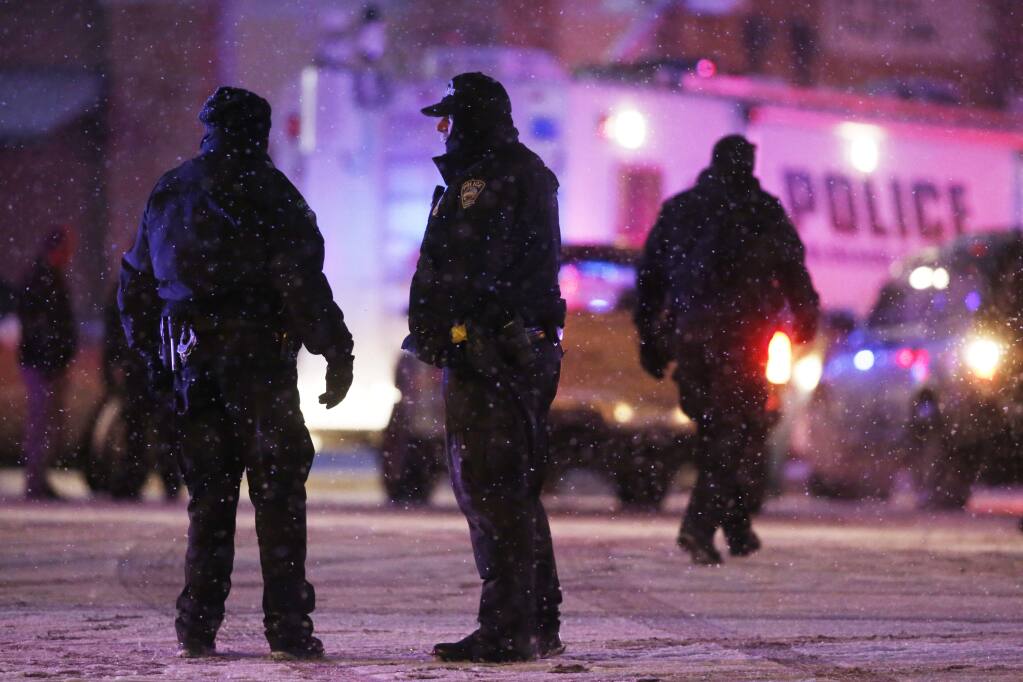Police confer at an intersection near the scene of a shooting at a Planned Parenthood clinic Friday, Nov. 27, 2015, in Colorado Springs, Colo. A gunman opened fire at the clinic on Friday, authorities said, wounding multiple people. (AP Photo/David Zalubowski)