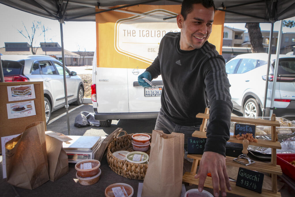 Oscar Delgado operates The Italian Corner, a booth at the Tuesday farmer’s market in Lucchesi Park in east Petaluma._Tuesday, January 24, 2023._(CRISSY PASCUAL/ARGUS-COURIER STAFF)