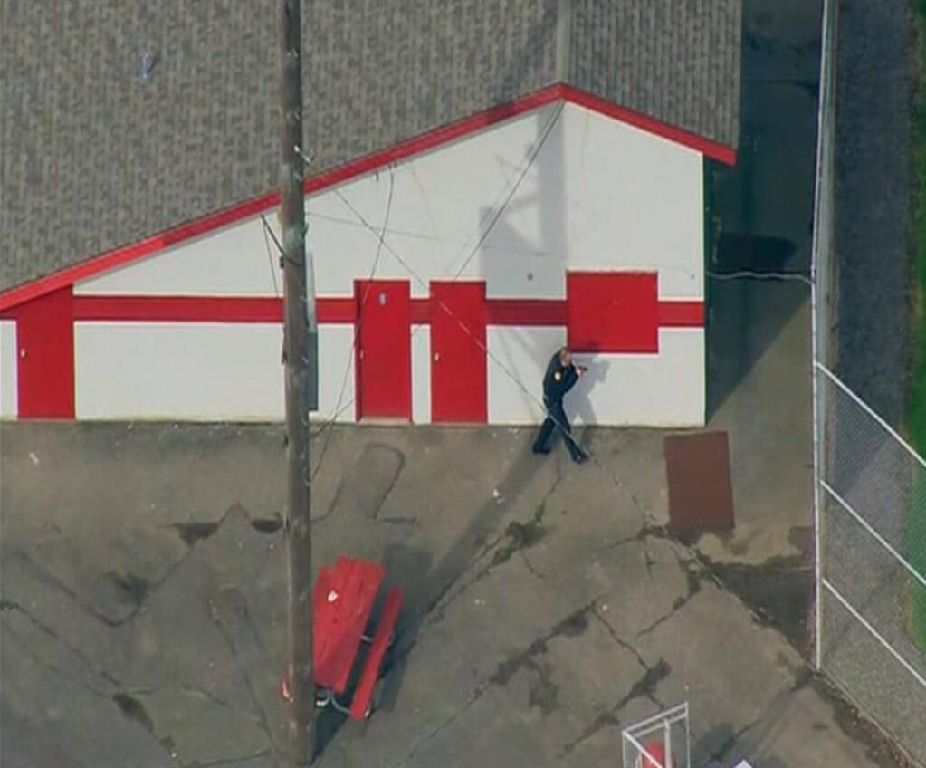 This image made from a video provided by KOMO shows emergency personnel responding after reports of a shooting at Marysville-Pilchuck High School in Marysville, Wash., Friday, Oct. 24, 2014. (AP Photo/KOMO) MANDATORY CREDIT