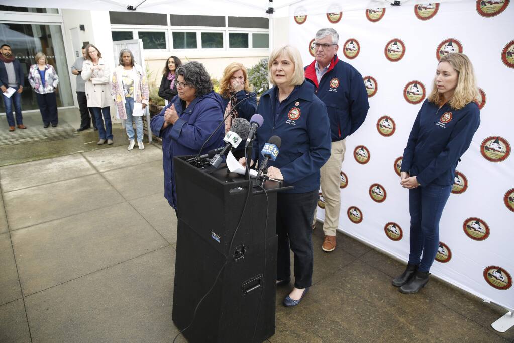 Supervisor Susan Gorin speaks during a press conference about the first community spread case of the coronavirus and the local response, in mid-March, 2020. Behind her are supervisors Shirlee Zane (hands to face), David Rabbitt and Lynda Hopkins. To the left rear is Dept. of Health Director Barbie Robison and Health Officer Sundari Mase . (BETH SCHLANKER/ The Press Democrat)