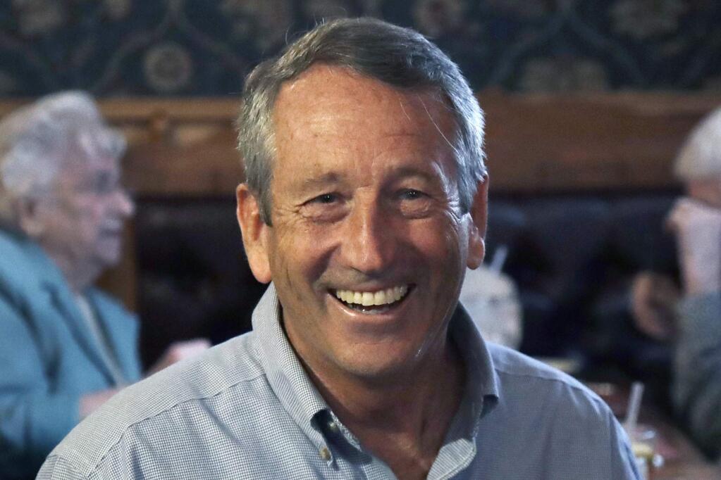 In this Sept. 19, 2019 file photo, Republican presidential candidate, former South Carolina Gov. Mark Sanford smiles as he talks with customers at the Puritan Backroom restaurant, during a campaign stop in Manchester, N.H. The three candidates running against Donald Trump in the Republican presidential primary aren't likely to make major donors swoon, as fears of retribution from Trump's orbit and an unwillingness to contribute to a losing effort are coupled with concerns about how to shape the GOP once Trump leaves the White House. (AP Photo/Elise Amendola)