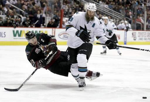 In this Feb. 18, 2017, file photo, San Jose Sharks center Joe Thornton, right, knocks the puck away from Arizona Coyotes right wing Shane Doan during the third period in Glendale, Ariz. Thornton underwent surgery to repair torn ligaments in his left knee before becoming a potential free agent this summer. (AP Photo/Chris Carlson, File)
