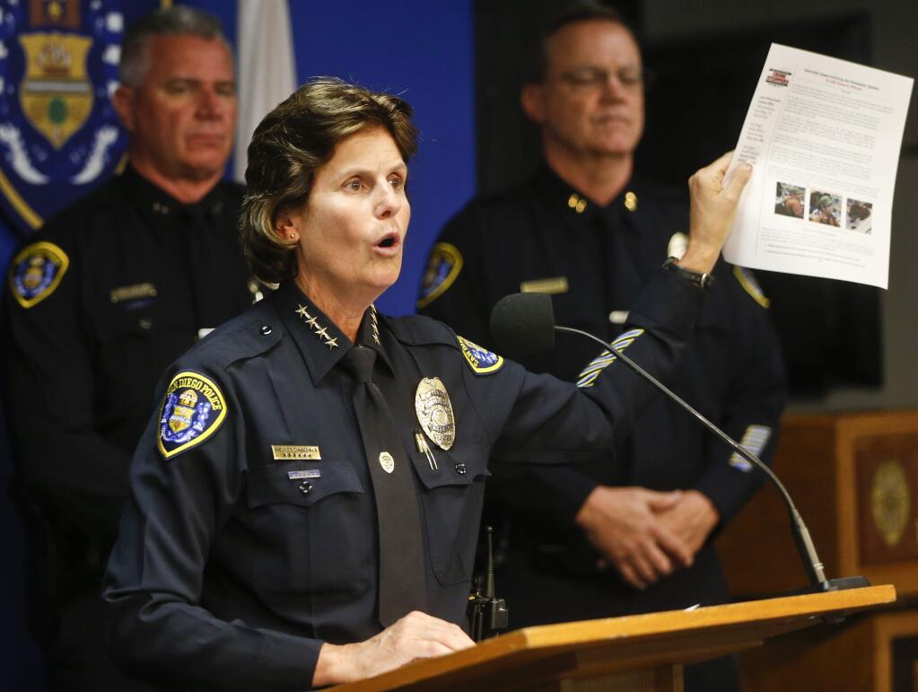 FILE - In this July 6, 2016, file photo, San Diego Police Chief Shelley Zimmerman holds up a information bulletin depicting the suspect in several murders of homeless people in downtown San Diego at a news conference in San Diego. A man injured during a series of attacks on homeless men in San Diego died at a hospital Sunday, July 10, police said. (AP Photo/Lenny Ignelzi, File)
