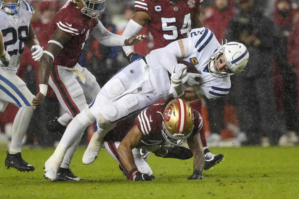Indianapolis Colts quarterback Carson Wentz is tackled by San Francisco 49ers safety Talanoa Hufanga in Santa Clara on Sunday, Oct. 24, 2021. (Tony Avelar / ASSOCIATED PRESS)