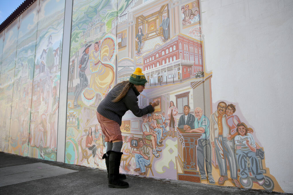 Artist Lauren Sinnott works on the mural "Ukiah Valley: Past, Present and Future" on West Church Street in Ukiah on Sunday, Nov. 8, 2020. (Beth Schlanker / The Press Democrat)