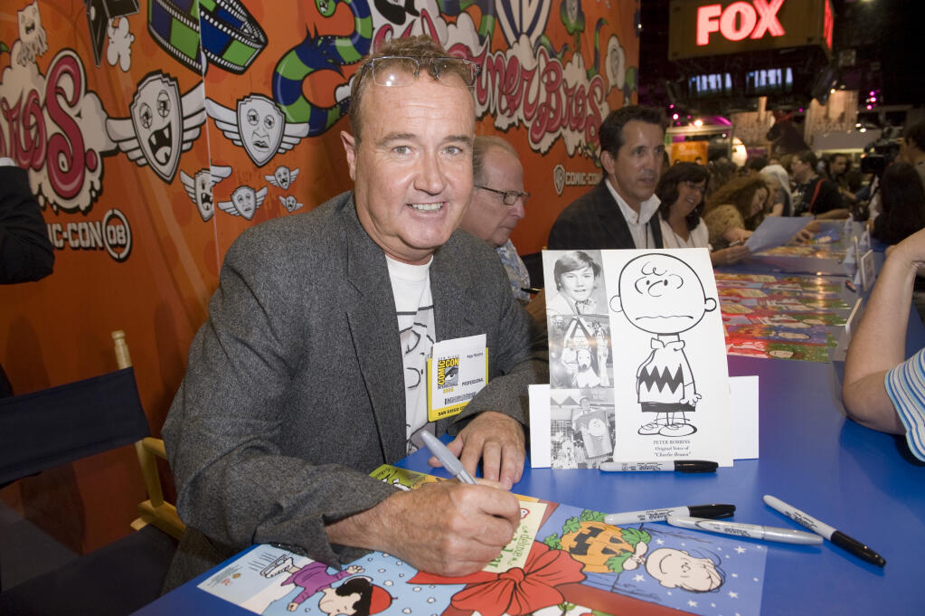 Peter Robbins, the original voice of Peanuts character Charlie Brown, signs autographs at Comic Con in San Diego on Friday, July 25, 2008. (AP Photo/Lisa Rose)