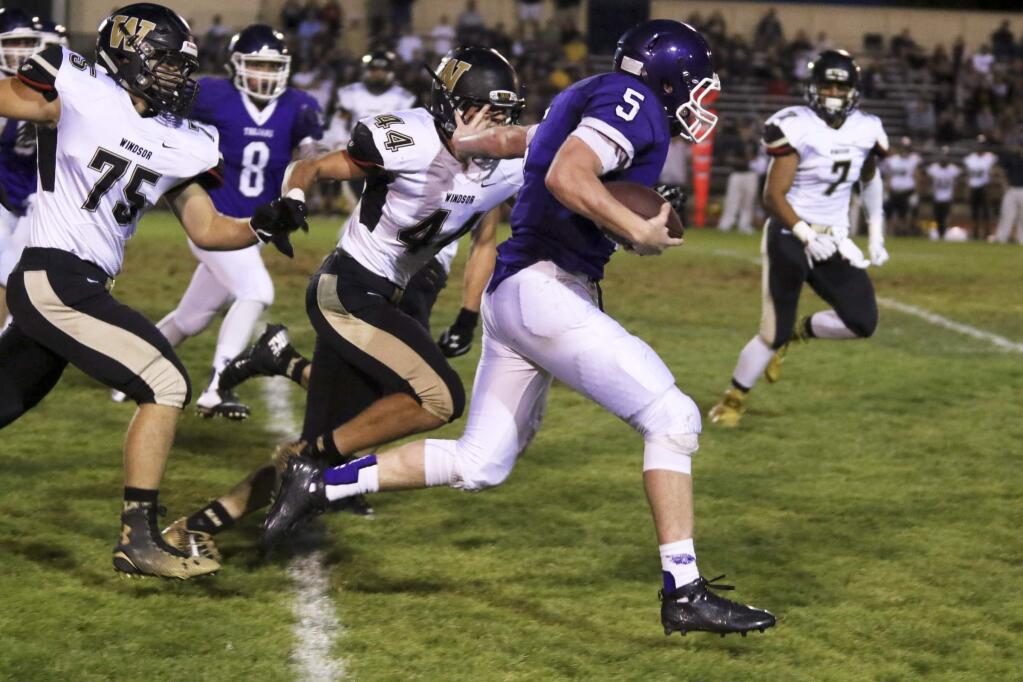 Petaluma's Brenden White picks up yardage on a QB keeper during their football game at Petaluma High School in Petaluma on Friday, August 28, 2015. Windsor went on to win the game 21-9. (SCOTT MANCHESTER/ARGUS-COURIER STAFF)