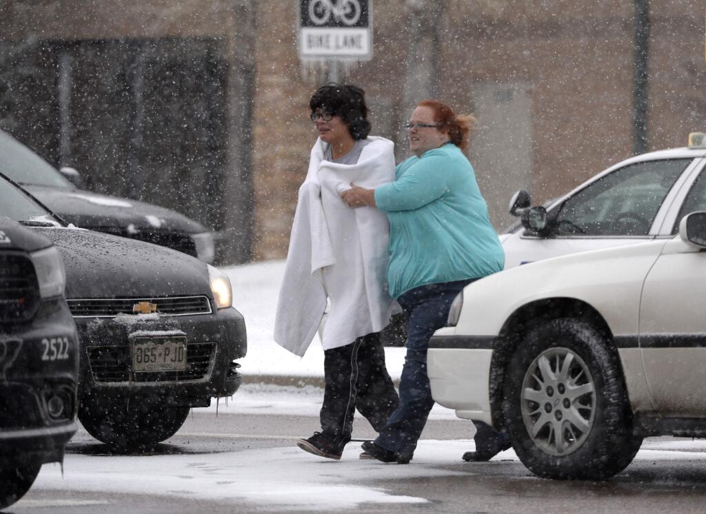 A person is escorted after reports of a shooting near a Planned Parenthood clinic Friday, Nov. 27, 2015, in Colorado Springs, Colo. A gunman opened fire at the clinic on Friday, authorities said, wounding multiple people. (Andy Cross/The Denver Post via AP) MAGS OUT; TV OUT; INTERNET OUT; NO SALES; NEW YORK POST OUT; NEW YORK DAILY NEWS OUT; MANDATORY CREDIT
