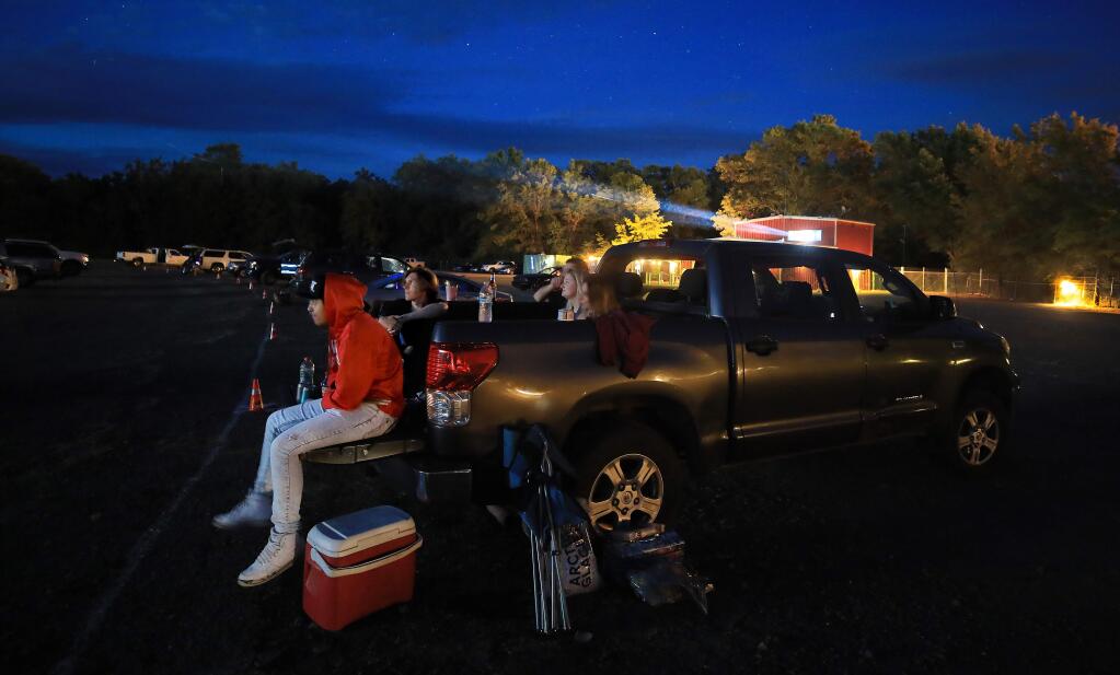 Ukiah residents Shannon Portis, Connor Denoeu, Nolan Reilly, Olivia Fryear and Bella Denoeu take in a flick at the Lakeport Automovies, Wednesday, June 10, 2020 in Lake County. (Kent Porter / The Press Democrat) 2020