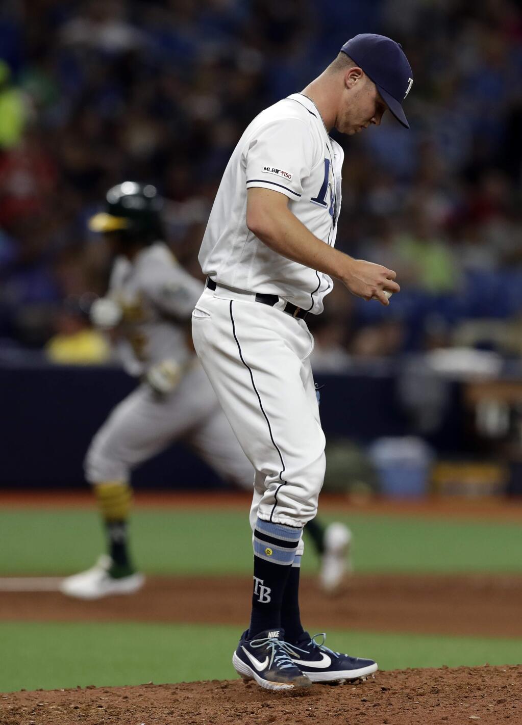 Tampa Bay Rays relief pitcher Emilio Pagan kicks the dirt as Oakland Athletics' Khris Davis runs around the bases after his home run during the sixth inning of a baseball game Tuesday, June 11, 2019, in St. Petersburg, Fla. (AP Photo/Chris O'Meara)