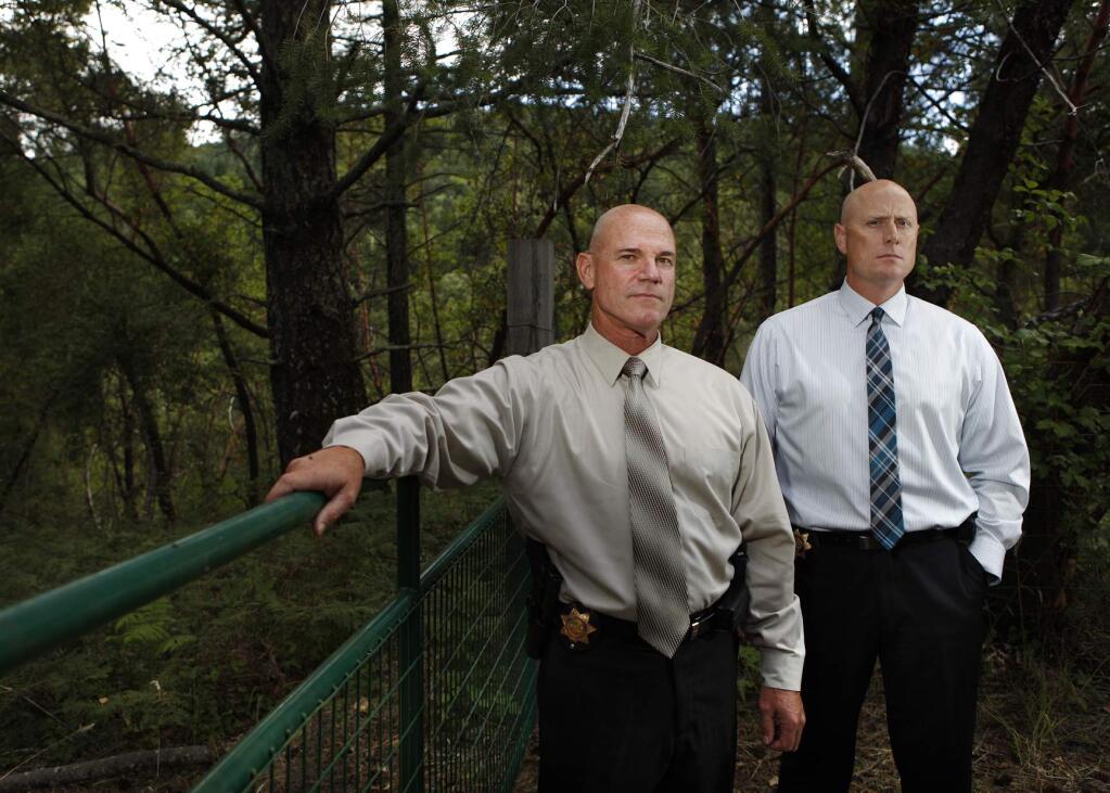 Det. Gary Freitas, left, and Det. Jesse Hanshew of the Sonoma County Sheriff's Department stand near the site where 3 bodies were found by police in the 1970s in connection with the Santa Rosa hitchhiker murders. Photo taken in Santa Rosa, California on Monday, July 18, 2011. (Beth Schlanker / The Press Democrat)