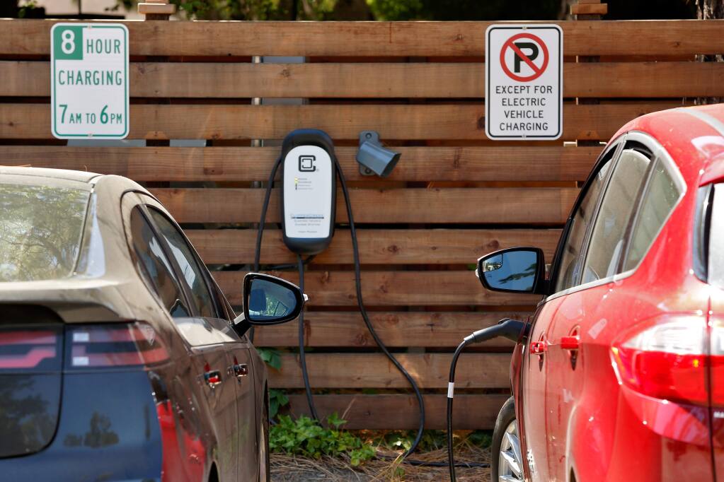 A pair of electric cars are plugged in at the bank of employee vehicle charging stations at the offices of Jackson Family Enterprises in Santa Rosa, California, on Wednesday, May 31, 2017. (Alvin Jornada / The Press Democrat)
