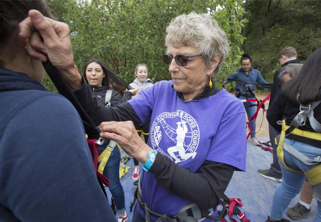 Diana Rhoten, who leads the adventure, helps a participant with her safety harness.The Challenge Sonoma ropes course has operated on the grounds of SDC for over thirty years. (Photo by Robbi Pengelly/Index-Tribune)