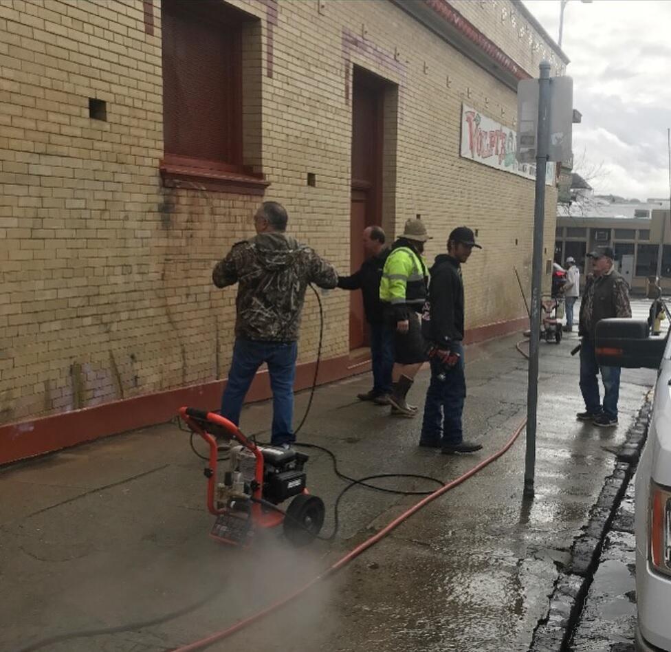 A crew of volunteers showed up in the rain on Thursday, Jan. 28, to clean Volpi’s after it was vandalized with graffiti overnight. (Volpi Instagram)