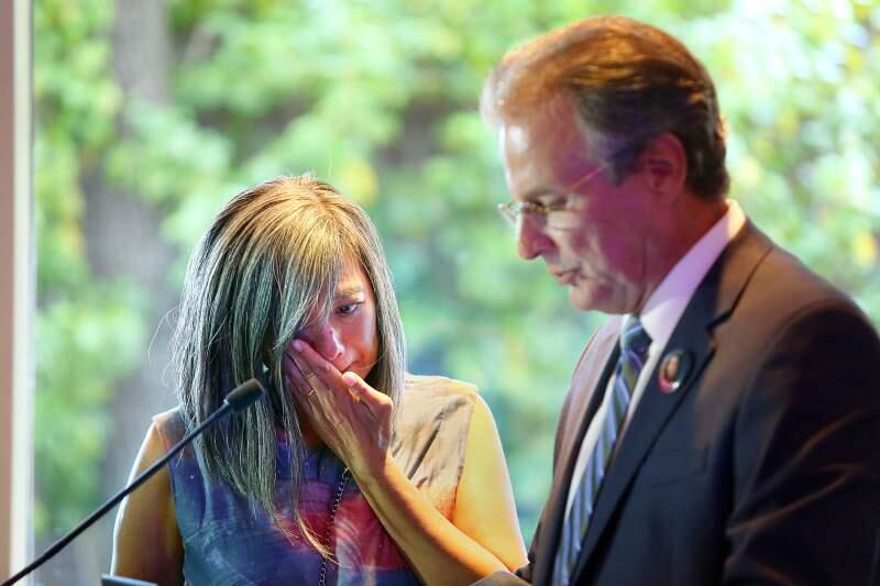 Violet Klaas wipes away tears as her husband Marc Klaas speaks about his daughter during a commemorative 20th anniversary event for his daughter Polly Klaas at the Fairmont Hotel in San Francisco, Tuesday, Oct. 1, 2013 (Conner Jay / Press Democrat file)