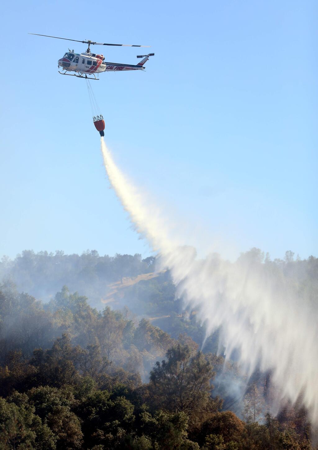 The Cal Fire helitack chopper from Boggs Mountain in Lake County, was one of two helicopters used in fighting the Canyon fire above Lake Berryessa, Monday, July 22, 2019 in Napa County. (Kent Porter / The Press Democrat) 2019