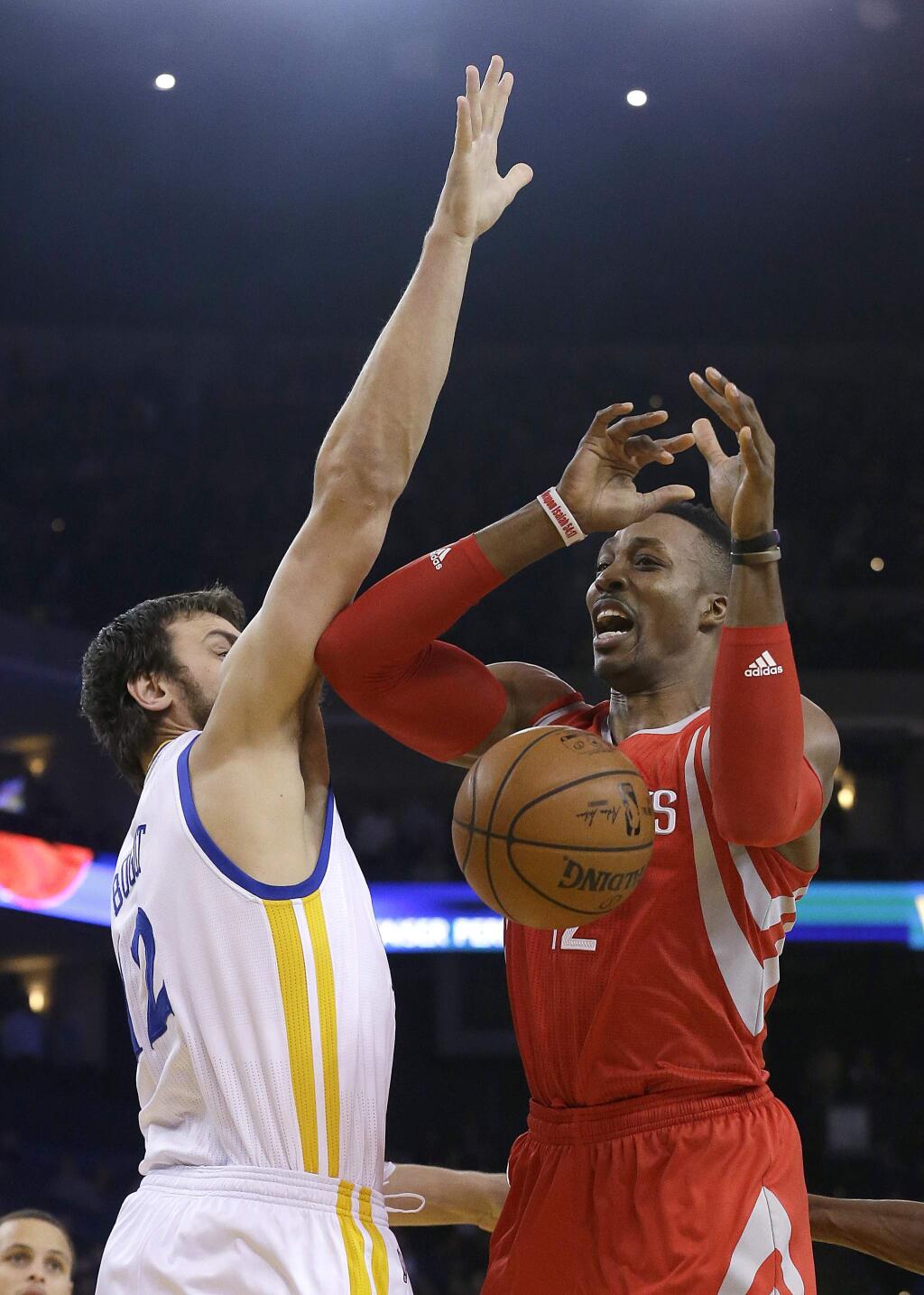 Houston Rockets center Dwight Howard, right, loses the ball as he is guarded by Golden State Warriors center Andrew Bogut during the first half of an NBA basketball game in Oakland, Calif., Wednesday, Jan. 21, 2015. (AP Photo/Jeff Chiu)