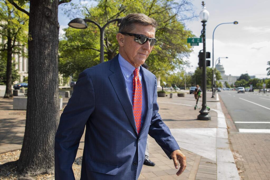 FILE - In this Sept. 10, 2019 file photo, Michael Flynn, President Donald Trump's former national security adviser, leaves the federal court following a status conference in Washington. FBI Director Christopher Wray has ordered an internal review into possible misconduct in the investigation of former Trump administration national security adviser Michael Flynn. That's according to an FBI statement issued Friday. (AP Photo/Manuel Balce Ceneta)