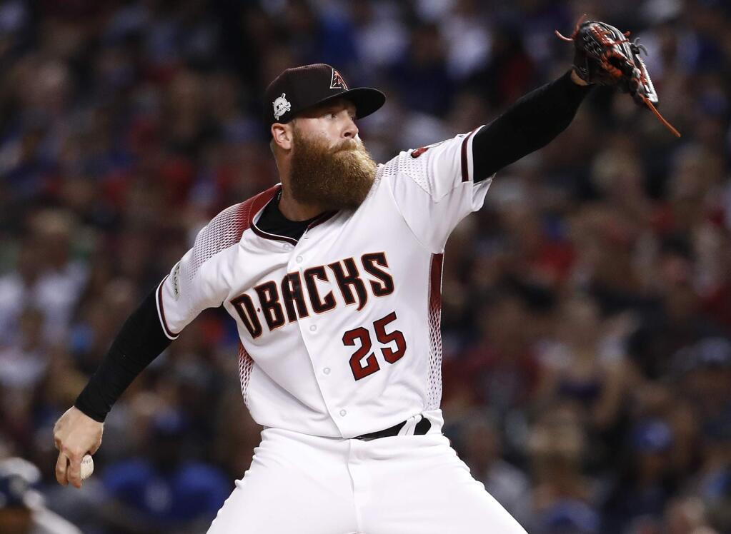 FILE - In this Oct. 9, 2017, file photo, Arizona Diamondbacks relief pitcher Archie Bradley (25) throws against the Los Angeles Dodgers during the seventh inning in Game 3 of baseball's National League Division Series in Phoenix. An intriguing possibility for the Diamondbacks is to have dynamic setup man Archie Bradley move in to the closer's spot. (AP Photo/Rick Scuteri, File)