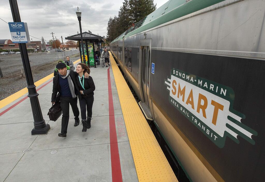 SMART riders exit the train at the Railroad Square station in Santa Rosa in December 2019. (John Burgess/The Press Democrat)