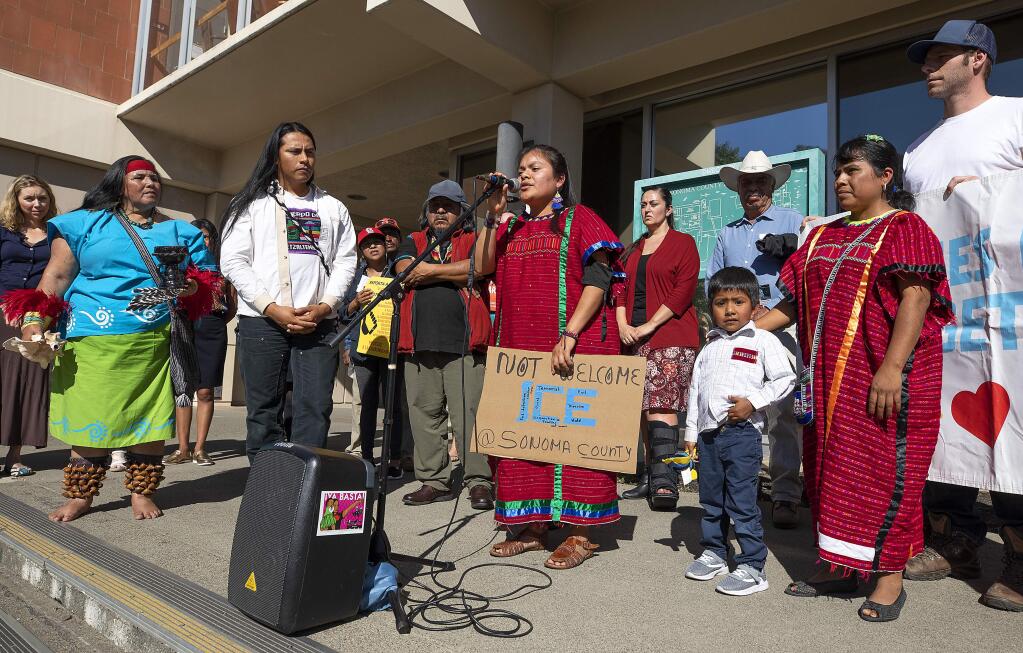 Miracle Merino, with the Movimiendo della Union Indigena s speaks to a small group gathered to protest in front of Sonoma County Superior Court where ICE officers arrested at least two people a week ago. (John Burgess/The Press Democrat)