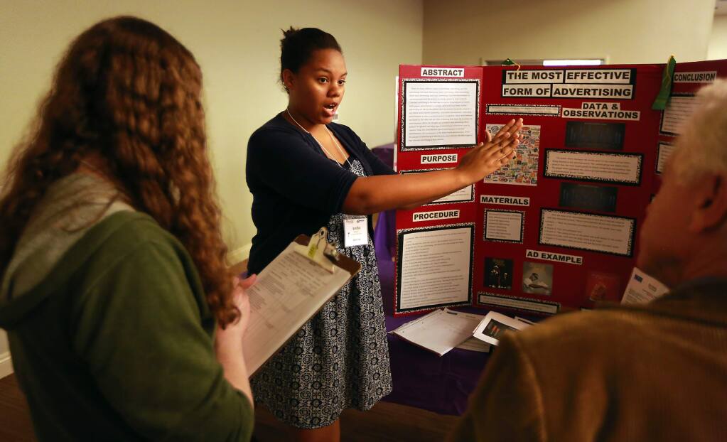 Amiha Morrow of Technology High School explains her advertising experiment to judges a the Synopsys-Sonoma County Science Fair for middle and high school students on Friday, February 27, 2015. (Photo by John Burgess/The Press Democrat)