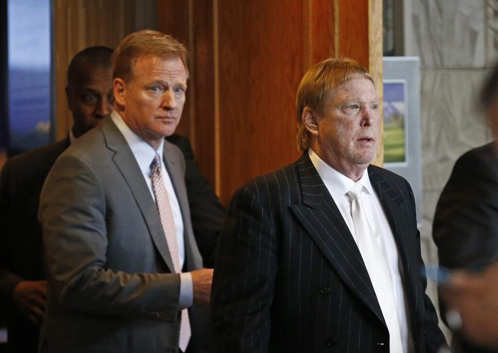 Oakland Raiders owner Mark Davis, right, emerges from the NFL football annual meetings with NFL Commissioner Roger Goodell, left, after owners approved the move of the Raiders to Las Vegas, Monday, March 27, 2017, in Phoenix. (AP Photo/Ross D. Franklin)