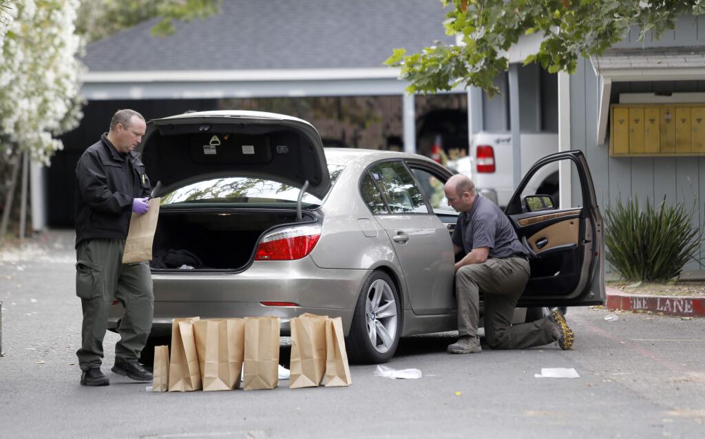 Sonoma County sheriff's deputies and detectives collect evidence from a gang related shooting Monday morning near a Corby Avenue apartment complex in Santa Rosa, July 6, 2015. (BETH SCHLANKER/ The Press Democrat)