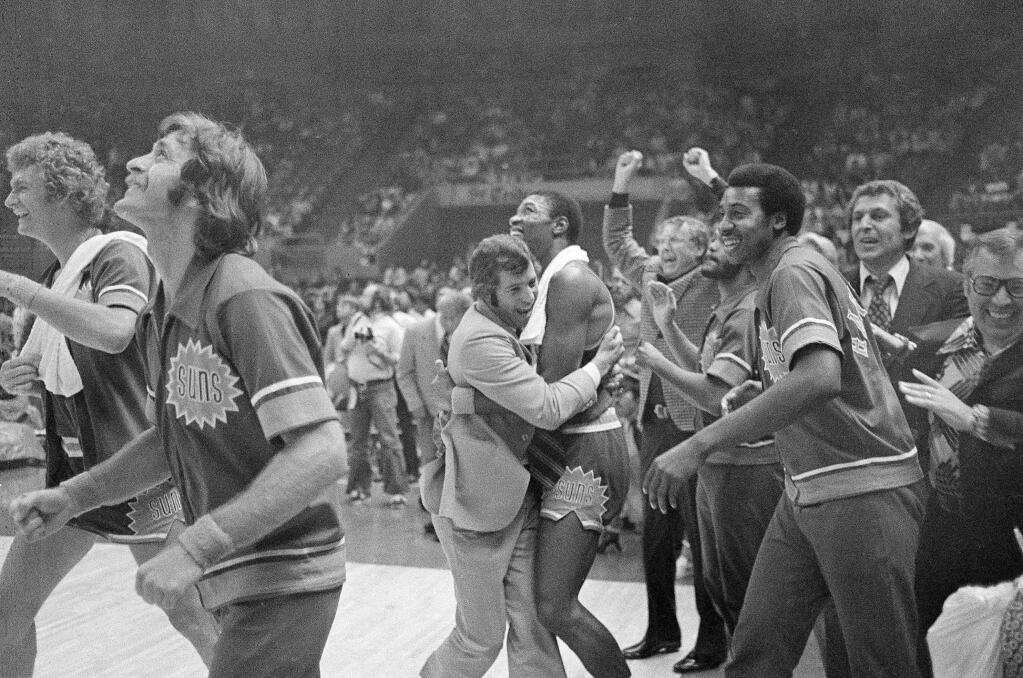 Phoenix Suns' coach John MacLeod hugs Curtis Perry as his Suns defeated the Golden State Warriors 94-86 to win the NBA Western Conference title, May 16, 1976. (AP Photo/Jim Palmer)