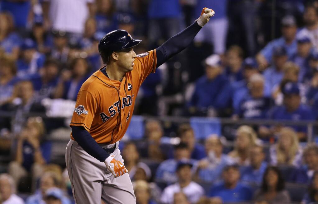 Houston Astros' George Springer celebrates after his solo home run during the fifth inning in Game 1 of baseball's American League Division Series against the Kansas City Royals, Thursday, Oct. 8, 2015, in Kansas City, Mo. (AP Photo/Orlin Wagner)