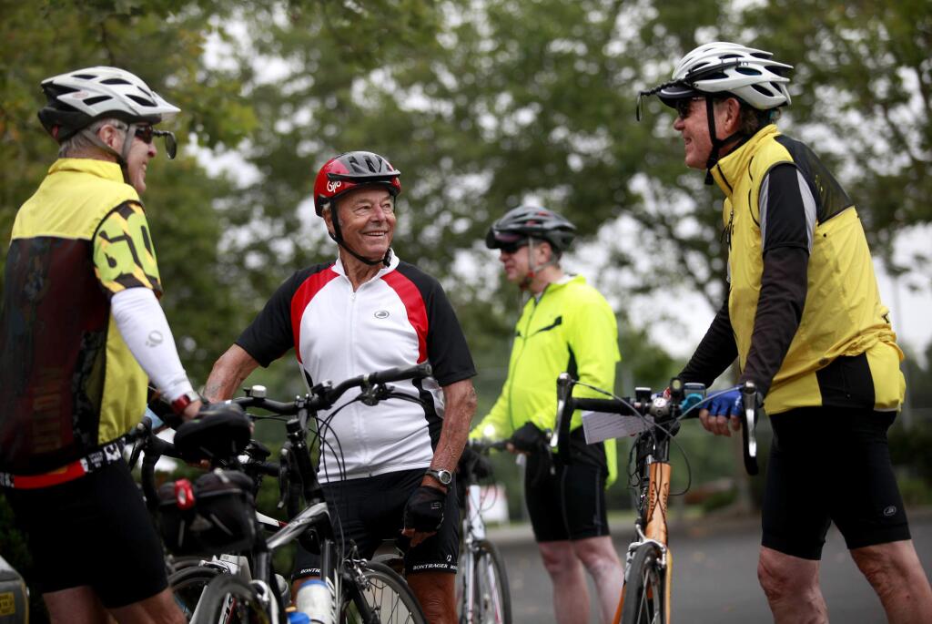 Geoffrey Newton, 88, center, talks with Doug Newberg, left, and Steve Strain at Esposti Park before going for a ride with the Friday Freewheelers group in Windsor, on Friday, July 18, 2014. (BETH SCHLANKER/ The Press Democrat)