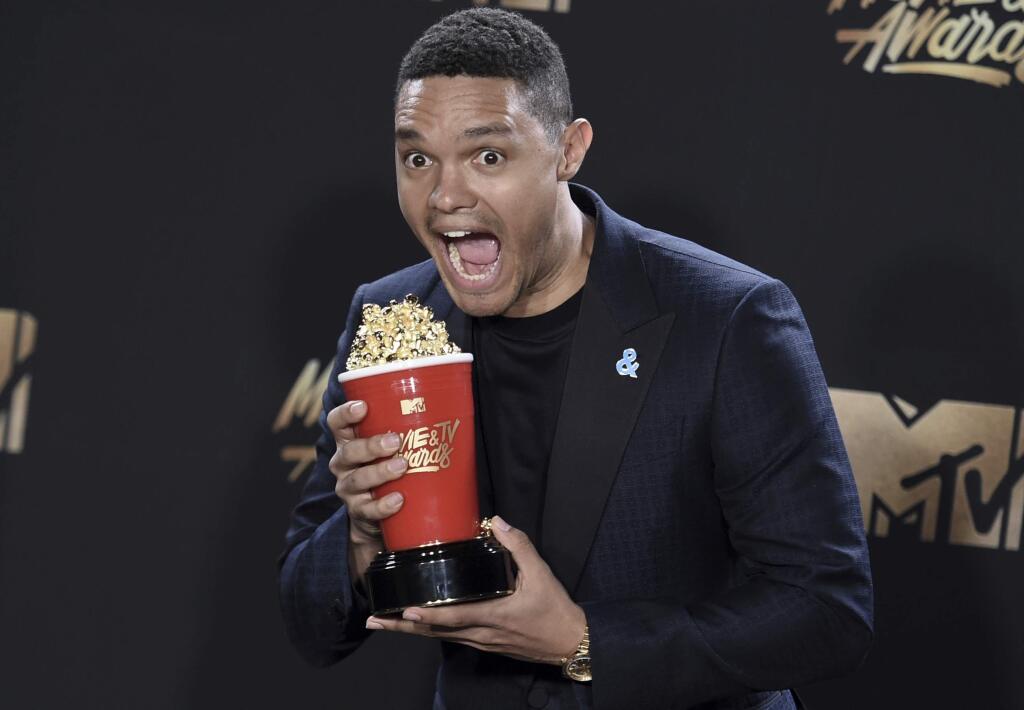 FILE -- In this May 7, 2017 file photo, South African Comedian Trevor Noah poses with the award for best host for 'The Daily Show' in the press room at the MTV Movie and TV Awards at the Shrine Auditorium in Los Angeles. Using vulgar language, U.S. President Donald Trump on Thursday, Jan. 11, 2018, questioned why the U.S. would accept more immigrants from Haiti and 'shithole countries' in Africa rather than places like Norway in rejecting a bipartisan immigration deal. (Richard Shotwell/Invision/AP, File)