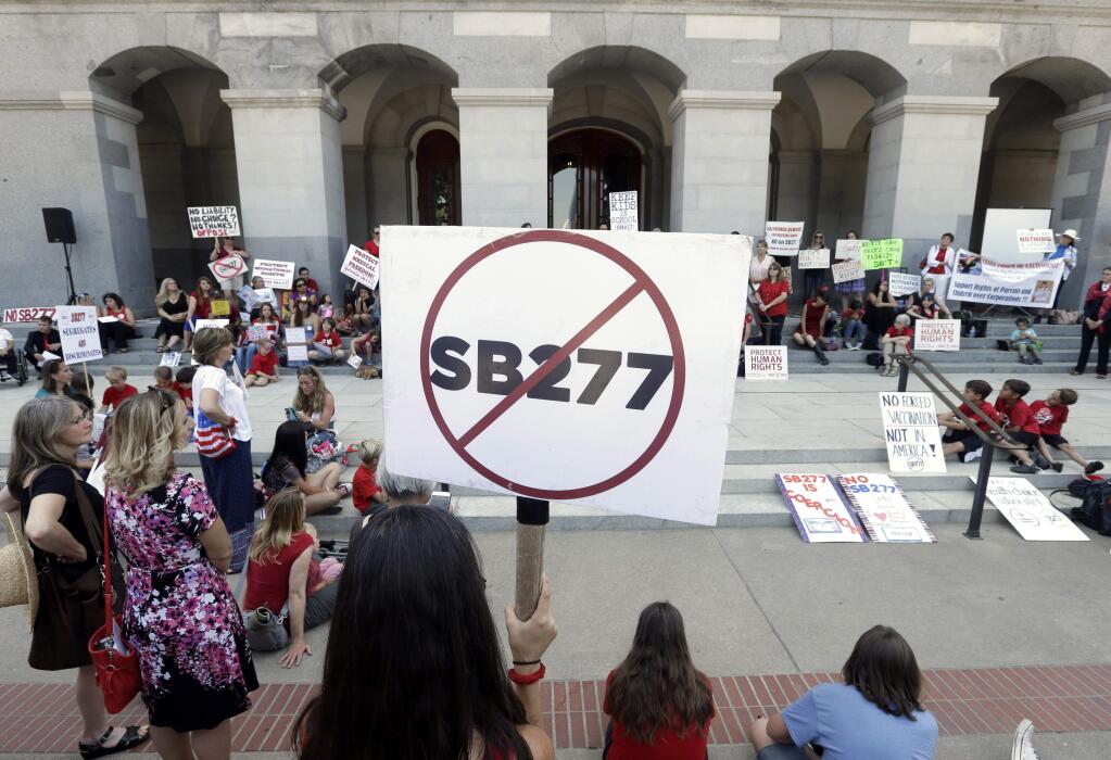 Opponents of a measure requiring nearly all California school children to be vaccinated gathered on the west steps of the Capitol after lawmakers approved the bill, in Sacramento, Calif., Thursday, June 25, 2015. The bill, SB277 co-authored by state Sen. Richard Pan, D-Sacramento and Ben Allen D-Santa Monica was approved by the Assembly. (AP Photo/Rich Pedroncelli)