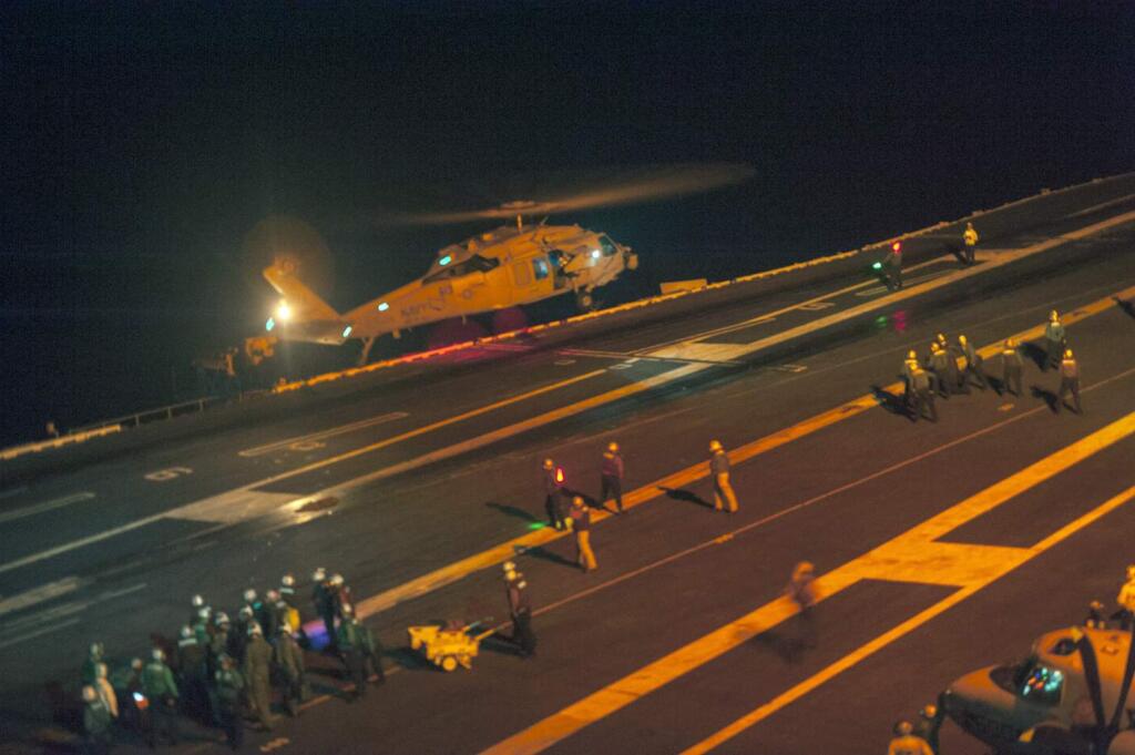 This photo provided by the US Navy, a MH-60S Sea Hawk helicopter lands on the flight deck of the Nimitz-class aircraft carrier USS Carl Vinson (CVN 70) during search and rescue operations for a missing pilot on Friday, Sept. 12, 2014. (AP Photo/US Navy, MCS 2nd Class John Philip Wagner, Jr., Released)