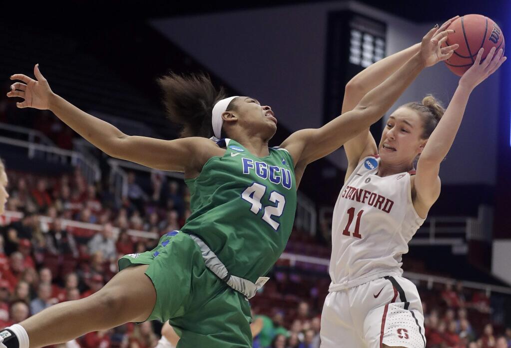 Stanford forward Alanna Smith (11) grabs a rebound against Florida Gulf Coast guard Tytionia Adderly (42) during the first half of a second-round game in the NCAA women's tournament in Stanford, Monday, March 19, 2018. (AP Photo/Jeff Chiu)