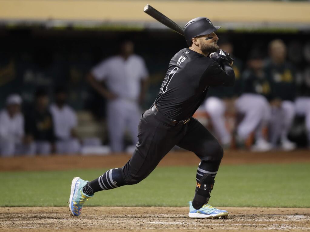 The San Francisco Giants' Kevin Pillar watches his two-run double off the Oakland Athletics' Lou Trivino during the eighth inning Saturday, Aug. 24, 2019, in Oakland. (AP Photo/Ben Margot)