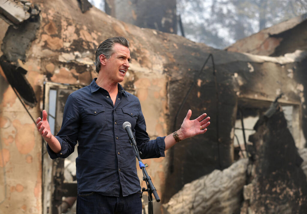 Gov. Gavin Newsom speaks at a press conference Oct. 1 while touring areas damaged by the Glass fire at Foothills Elementary School near St. Helena. On Tuesday, March 30, 2021, Gov. Newsom announced the state will hire nearly 1,400 additional firefighters as dry weather portends a troubling wildfire season. (Christopher Chung / The Press Democrat)