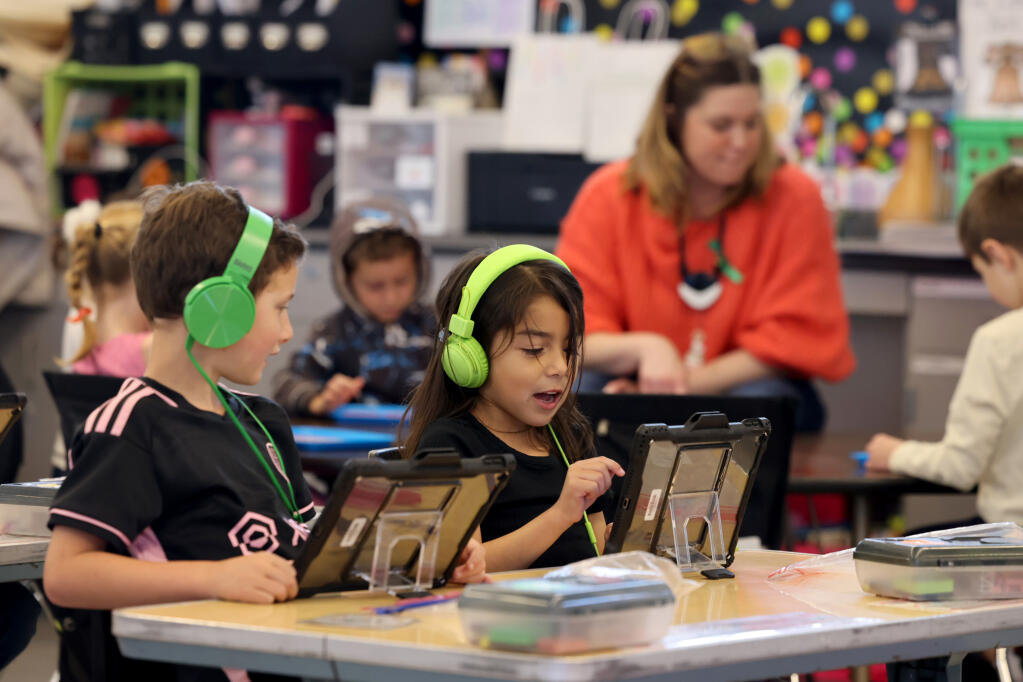 Kindergartners Derek Pinckney, left, and Cami Aguilera complete questions in a literacy application on their iPads at Willow Elementary School in Napa, Wednesday, March 20, 2024. (Beth Schlanker / The Press Democrat)