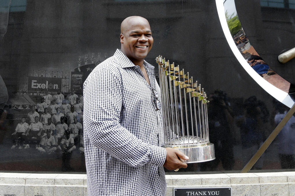 FILE - Former Chicago White Sox player and Hall of Famer Frank Thomas holds the 2005 World Series Champion trophy before a baseball game between the Kansas City Royals and the Chicago White Sox in Chicago, in this Saturday, July 18, 2015, file photo. Frank Thomas has found his Field of Dreams. The Hall of Famer has headed a venture that bought controlling interest in Go the Distance Baseball’s stake of All-Star Ballpark Heaven and the Field of Dreams Movie Site. The company said Thursday, Sept. 30, 2021, that This is Heaven LLC, a company of the 53-year-old Thomas and Chicago real estate developer Rick Heidner, bought the interests in Go the Distance Baseball owned by the Denise M. Stillman Trust.(AP Photo/Nam Y. Huh, File)