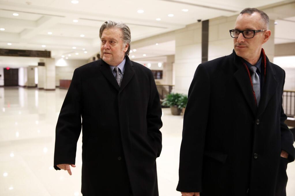 Former White House strategist Steve Bannon, left, leaves a House Intelligence Committee meeting where he was interviewed behind closed doors on Capitol Hill, Tuesday, Jan. 16, 2018, in Washington. (AP Photo/Jacquelyn Martin)