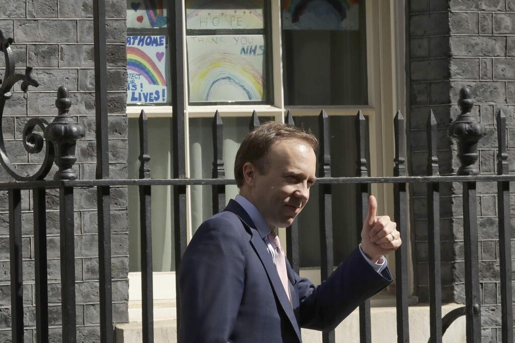 Britain's Health Secretary Matt Hancock gives a thumbs-up to the media as he leaves 10 Downing Street, London, after it was announced that British Prime Minister Boris Johnson's partner Carrie Symonds has given birth to a baby boy, Wednesday, April 29, 2020. (AP Photo/Matt Dunham)