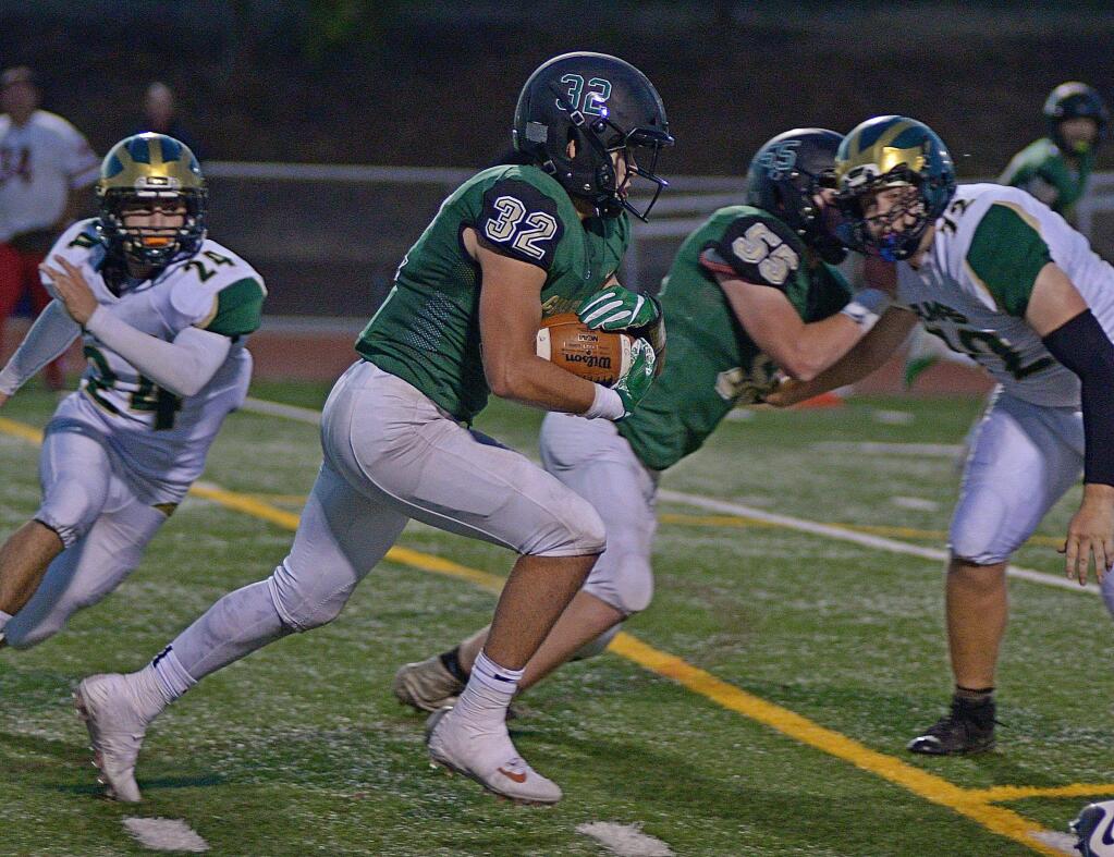 SUMNER FOWLER/FOR THE ARGUS-COURIERCasa Grande's Alex Johnson (32) and Jack Green (55) run into Vine Valley Athletic League play Friday night on the Casa field against Justin-Siena.