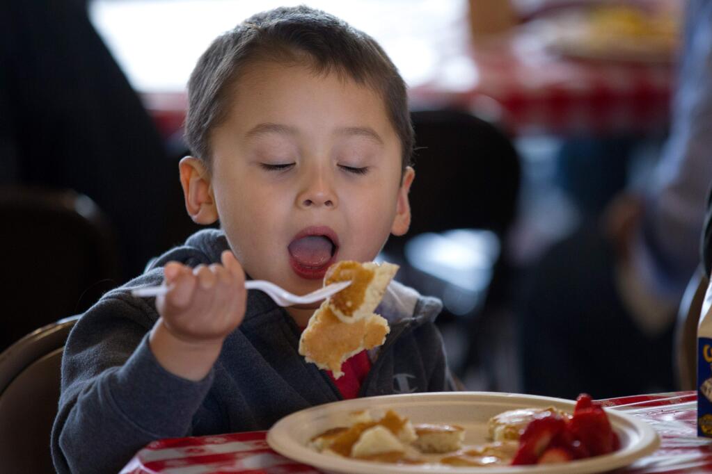 Lucas Grossman, 3, of Petaluma, eats pancakes at the Rancho Adobe Firefighters' Association Pancake Breakfast in Penngrove, on Saturday, July 6, 2019. (Photo by Darryl Bush / For The Press Democrat)