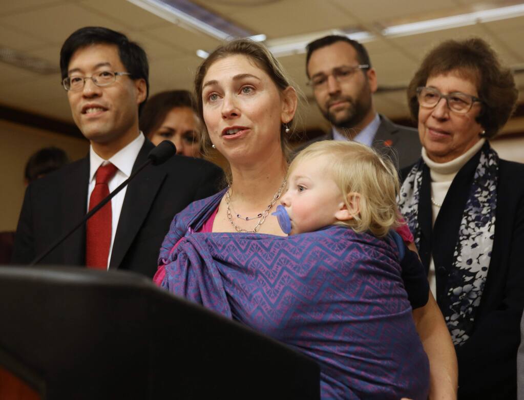 Leah Russin, of Palo Alto, holds her son, Leo, 16 months, as she speaks in support of proposed legislation that would require parents to vaccinate all school children, during a news conference in Sacramento, Calif., Wednesday Feb. 4, 2015. If approved by the Legislature and signed by the governor, the bill, co-authored by Sen. Richard Pan, D-Sacramento, left, and Ben Allen, D-Santa Monica, second from right, would make California one of only three states requiring such restrictions. At right is Sen. Lois Wolk, D-Davis who supports the measure.(AP Photo/Rich Pedroncelli)