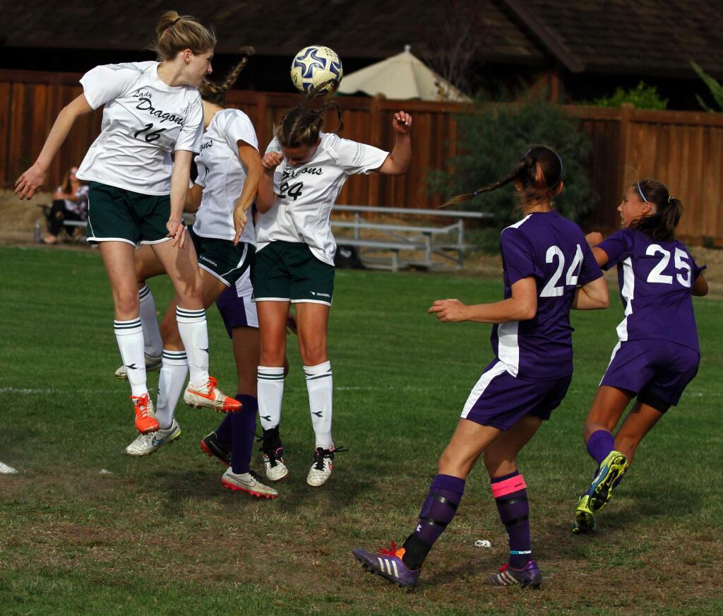 Bill Hoban/Index-TribuneSonoma Valley High's Lorne Baskin (16) and Jensen Hedley (24) were among the players trying for a header during last Thursday's match against Petaluma. The Lady Dragons topped the Trojans 1-0.