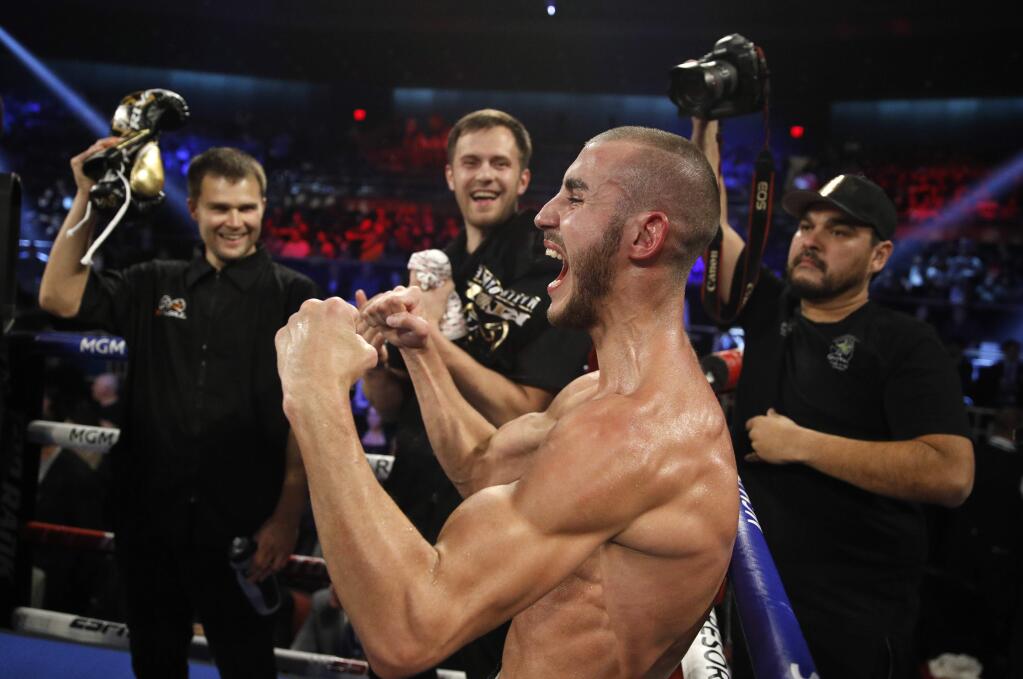FILE - In this Saturday, Oct. 20, 2018 file photo, Maxim Dadashev celebrates after defeating Antonio DeMarco during a junior welterweight bout in Las Vegas. On Saturday, July 20, 2019, doctors said Dadashev had surgery at a Maryland hospital for swelling on his brain after collapsing outside the ring after losing a match. (AP Photo/John Locher)