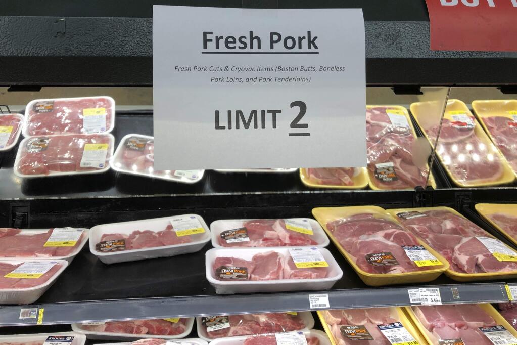 A sign at a Kroger store in Atlanta limits shoppers to two packages of pork on Tuesday, May 5, 2020. Kroger is limiting meat purchases, like a number of other grocery retailers, due to supply concerns amid the COVID-19 pandemic. (AP Photo/Jeff Amy)