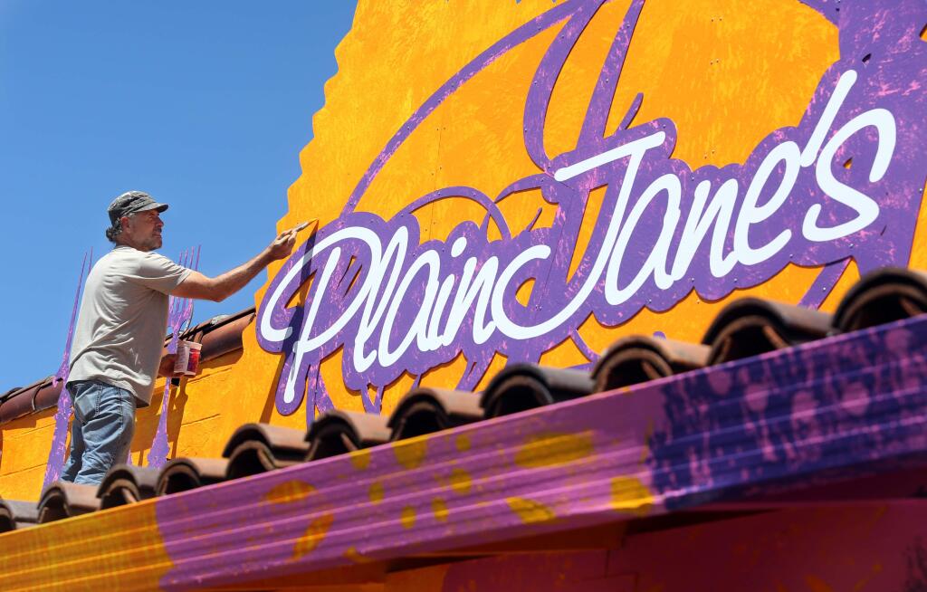 Artist Rico Martin adding his colorful touch to Plain Jane's in Boyes Hot Springs, in July 2015. (CRISTA JEREMIASON / The Press Democrat)