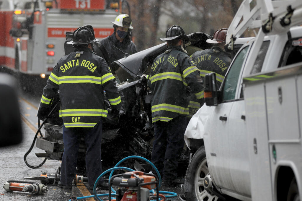 Santa Rosa firefighters work to extricate two people who were killed in a collision, Monday, Jan. 4, 2021 on Highway 12 in Oakmont, (Kent Porter / The Press Democrat)